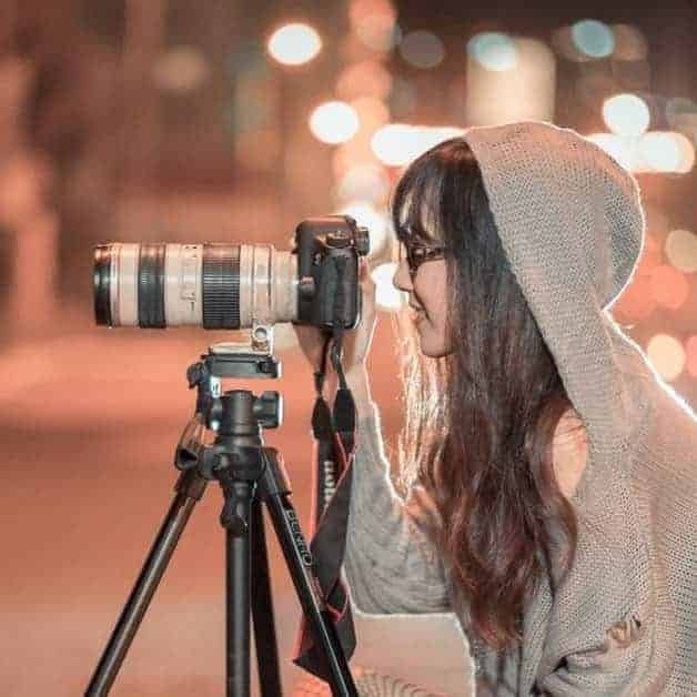 L'image représente une photographes devant son objectif.